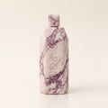 Marble Conditioner, an upright block of cream and plum veined marble with a hexagonal cap and SAPONE engraved down the front